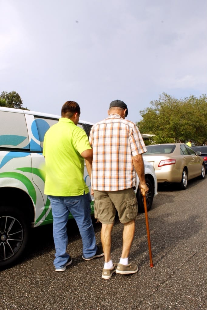 Caregiver driving an older adult to a medical appointment